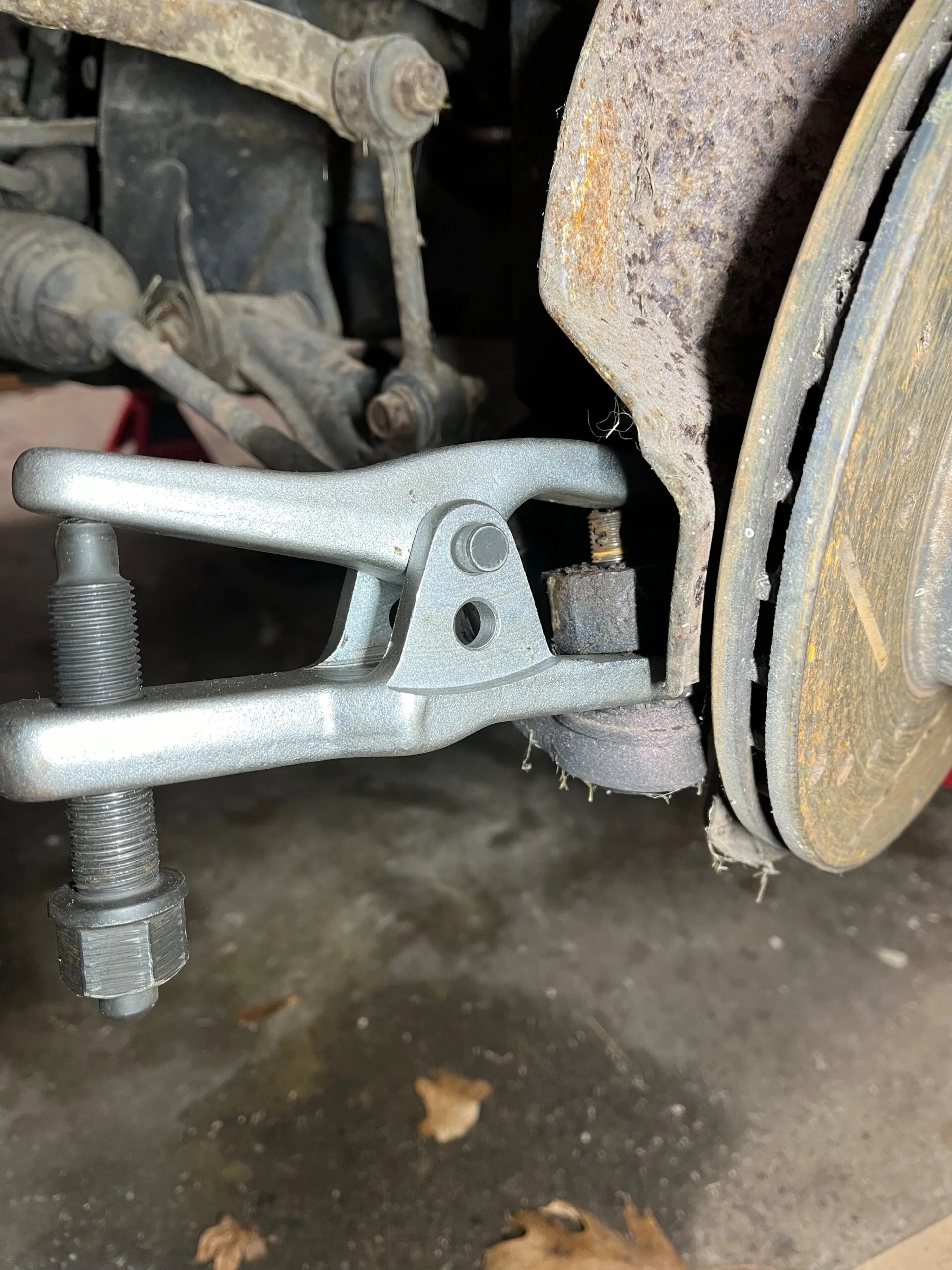 Ball joint separator tool on outer tie rod